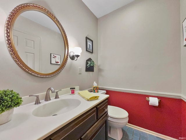 bathroom featuring vanity and toilet