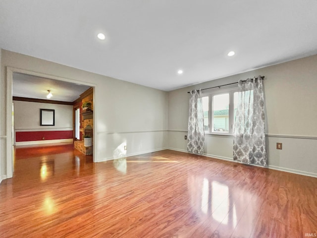 unfurnished room with hardwood / wood-style floors