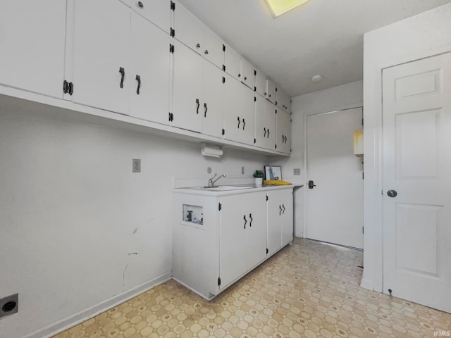 laundry room with hookup for an electric dryer, sink, washer hookup, and cabinets