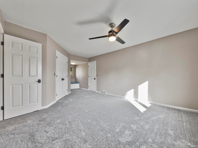 unfurnished bedroom featuring carpet flooring and ceiling fan