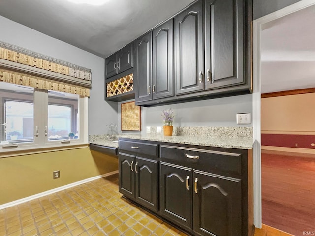 kitchen with light stone counters and light wood-type flooring