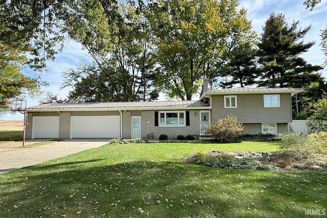 tri-level home featuring a garage and a front lawn