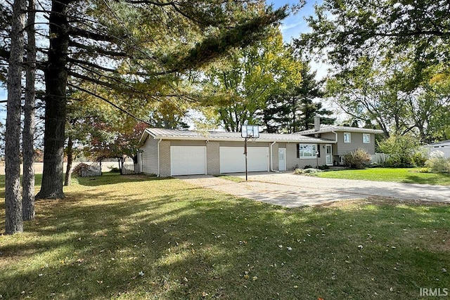 view of front of property with a front yard and a garage