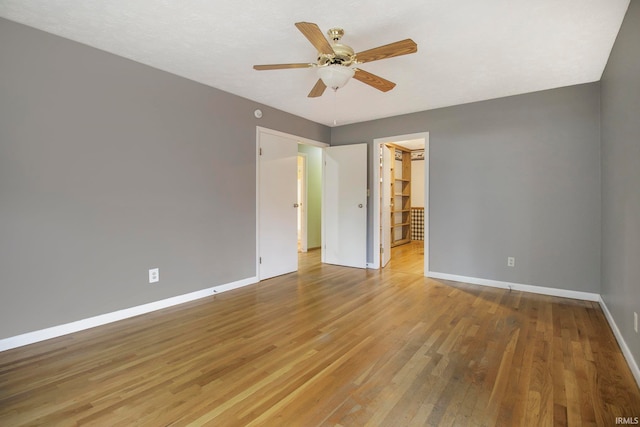 spare room featuring hardwood / wood-style floors and ceiling fan