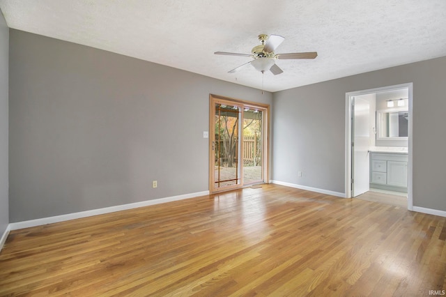 empty room with light hardwood / wood-style flooring, a textured ceiling, and ceiling fan