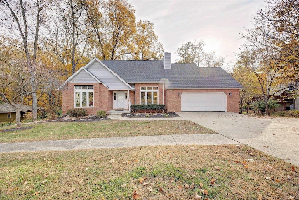 ranch-style home with a front lawn and a garage