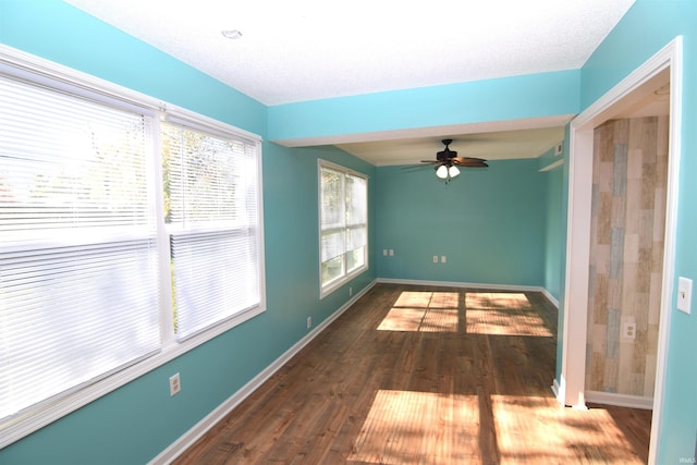 empty room featuring dark hardwood / wood-style floors, a textured ceiling, and ceiling fan