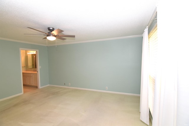 carpeted spare room featuring crown molding, a textured ceiling, sink, and ceiling fan