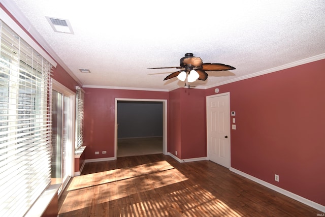 unfurnished room with ceiling fan, ornamental molding, a textured ceiling, and dark hardwood / wood-style floors