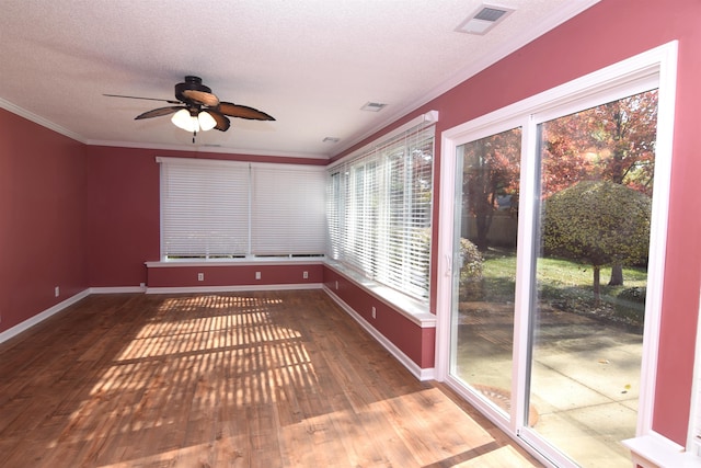 unfurnished sunroom featuring ceiling fan