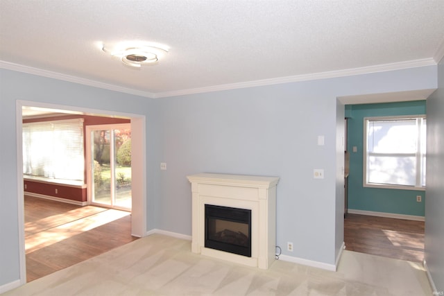 unfurnished living room with ornamental molding, a textured ceiling, and light hardwood / wood-style floors