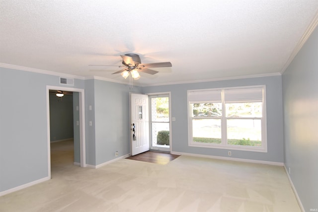 unfurnished room featuring ornamental molding, light colored carpet, and ceiling fan