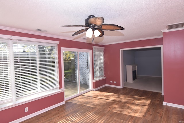 unfurnished room featuring ornamental molding, ceiling fan, a textured ceiling, and dark hardwood / wood-style flooring