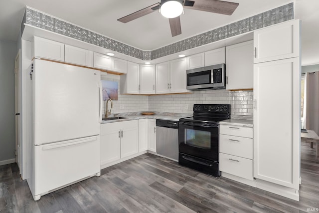 kitchen featuring white cabinetry, appliances with stainless steel finishes, and dark wood-type flooring