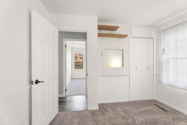 unfurnished bedroom featuring a closet and carpet floors