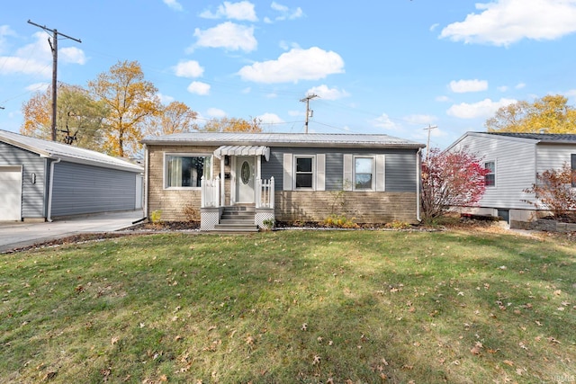 view of front facade featuring a front lawn, an outbuilding, and a garage