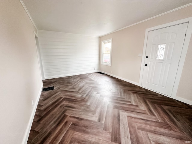 entrance foyer featuring parquet floors and ornamental molding