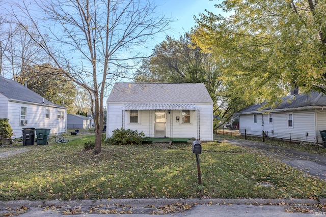 bungalow-style house with a front lawn