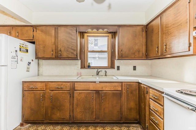 kitchen featuring sink and white appliances