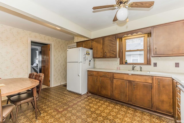 kitchen featuring white fridge, ceiling fan, and sink