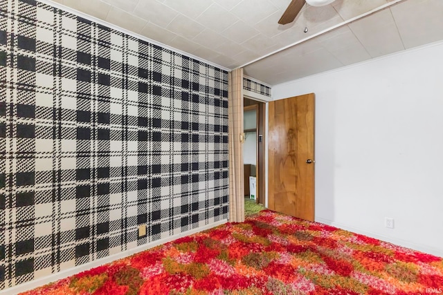 unfurnished bedroom featuring carpet floors and ceiling fan