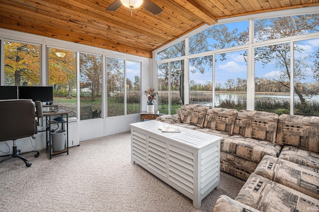 sunroom / solarium with a water view, ceiling fan, a wealth of natural light, and vaulted ceiling with beams