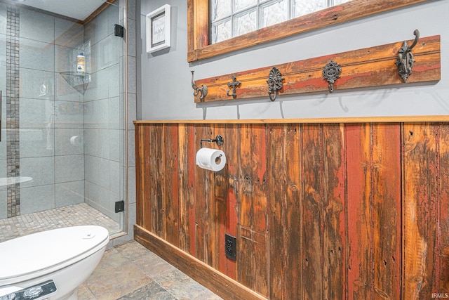 bathroom with wooden walls, toilet, and an enclosed shower