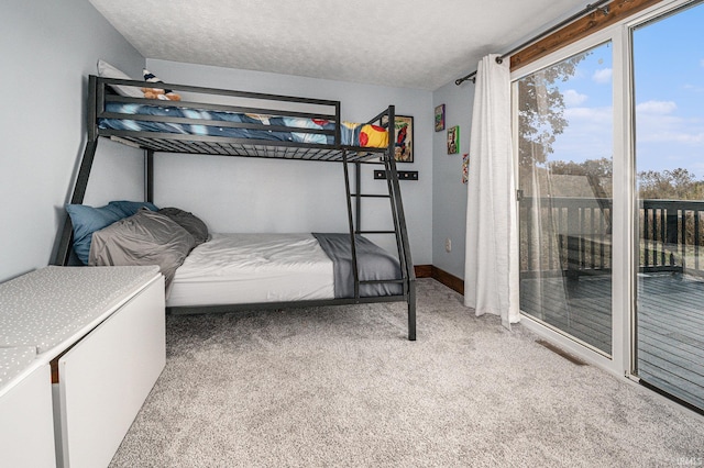 bedroom with light carpet, a textured ceiling, and access to exterior