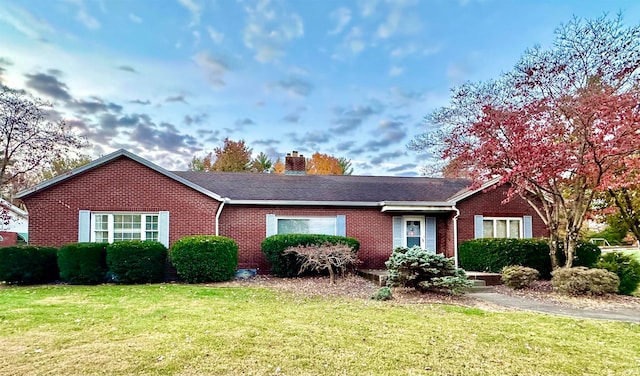 ranch-style home with a front lawn