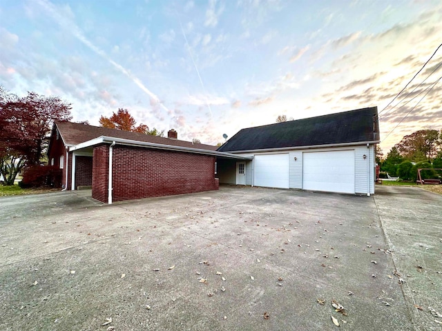 view of garage at dusk