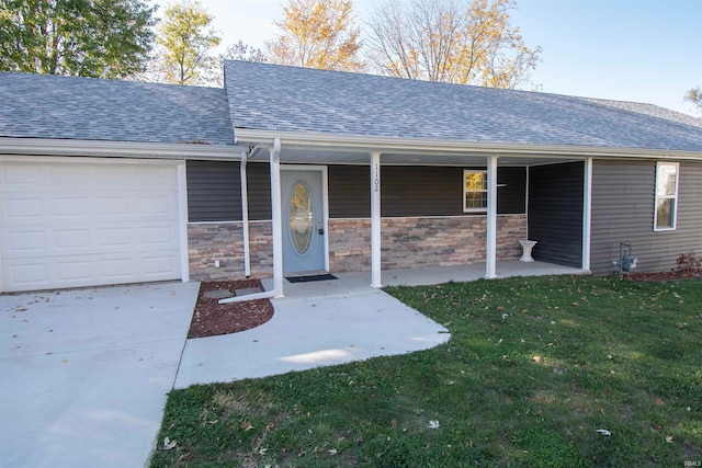 view of exterior entry with a yard and a garage