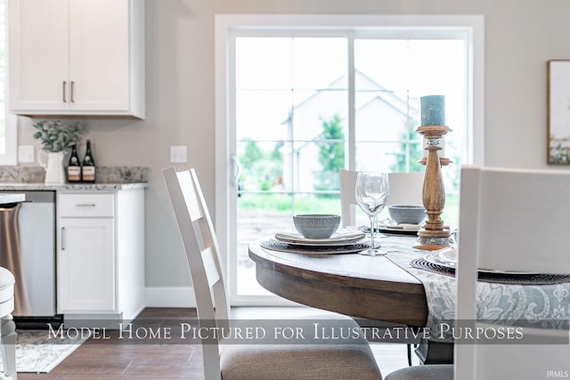 dining room featuring hardwood / wood-style floors and a healthy amount of sunlight