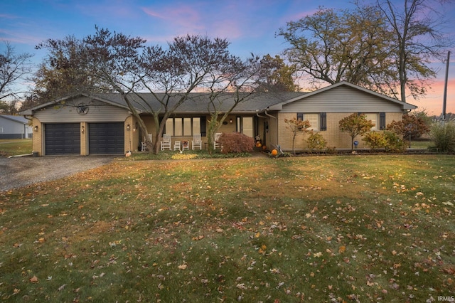 single story home with a yard and a garage