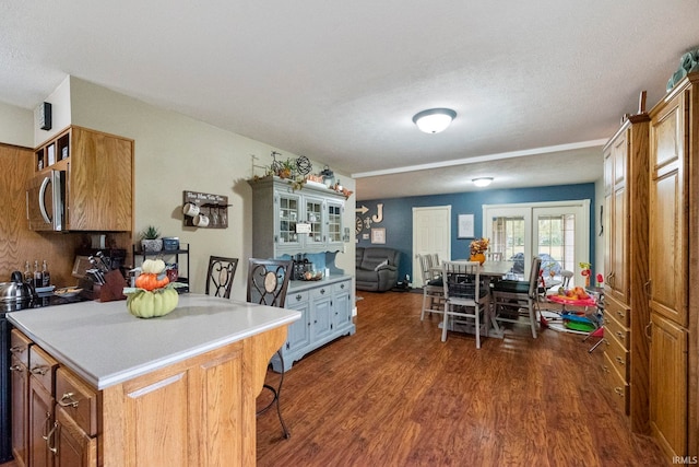 kitchen with dark wood-type flooring, a textured ceiling, and french doors