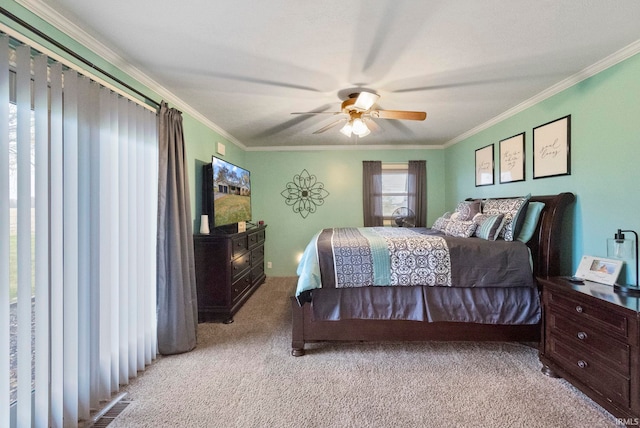 carpeted bedroom with crown molding and ceiling fan