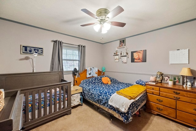 bedroom with ceiling fan and light carpet