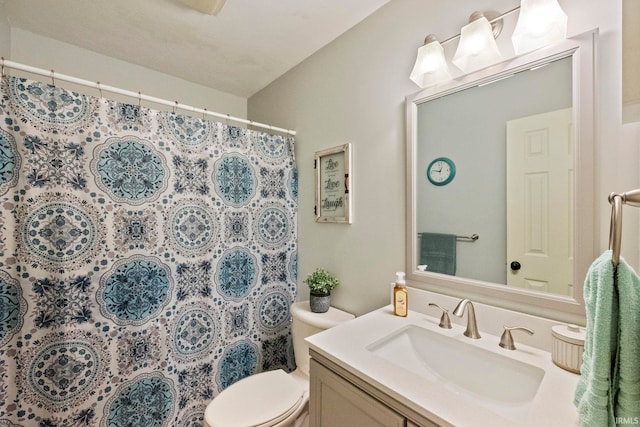 bathroom with vanity, toilet, and walk in shower