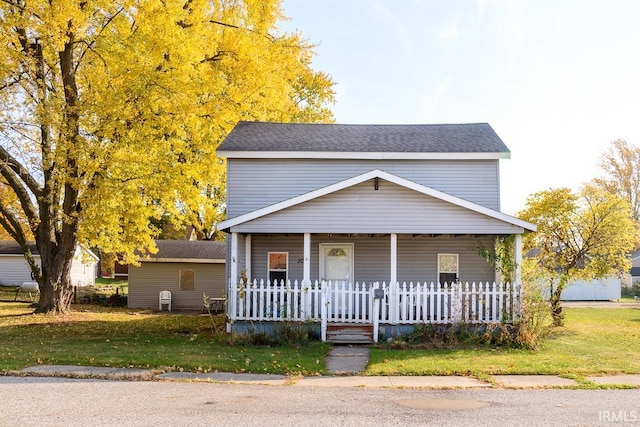 view of front of house with covered porch and a front yard