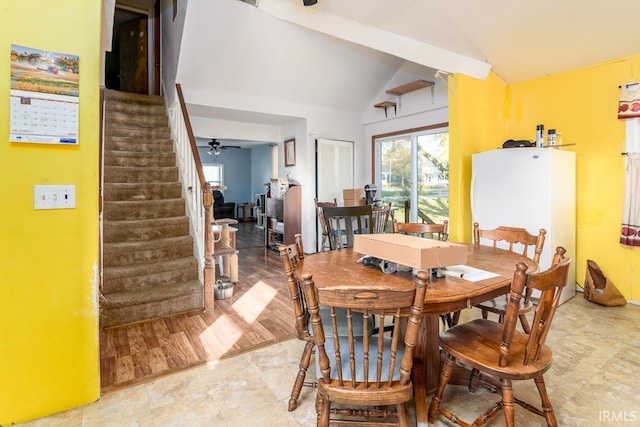 dining room with vaulted ceiling, hardwood / wood-style flooring, and ceiling fan