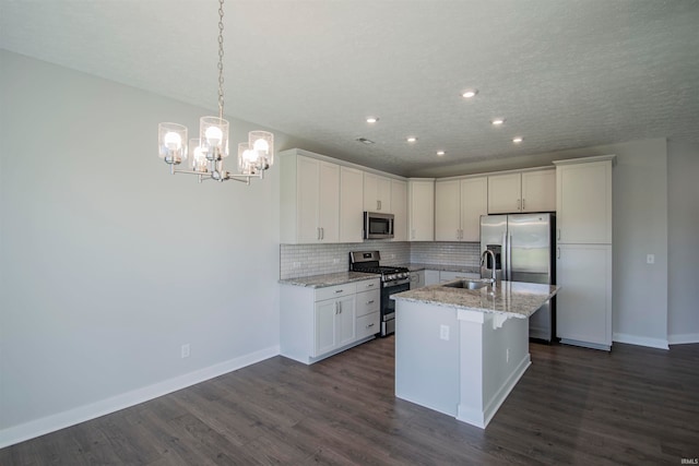 kitchen with appliances with stainless steel finishes, white cabinets, and dark hardwood / wood-style floors