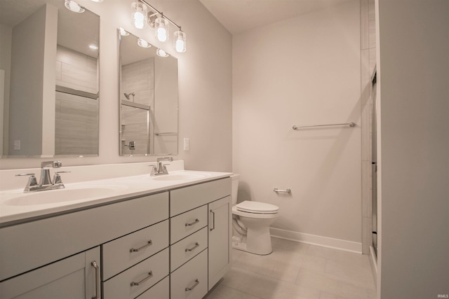 bathroom featuring vanity, toilet, and a shower with shower door