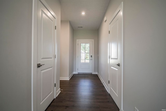 entryway with dark wood-type flooring and a textured ceiling