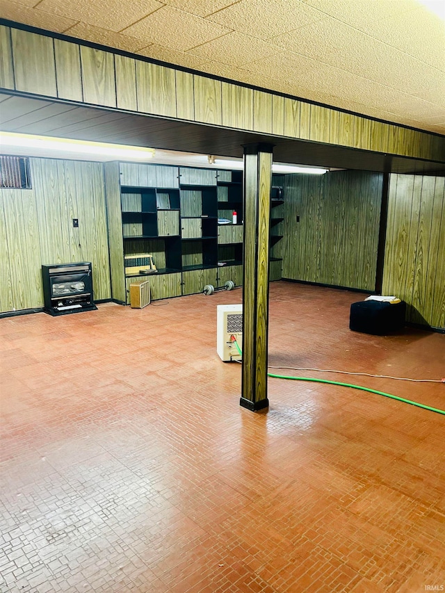 basement featuring wooden walls