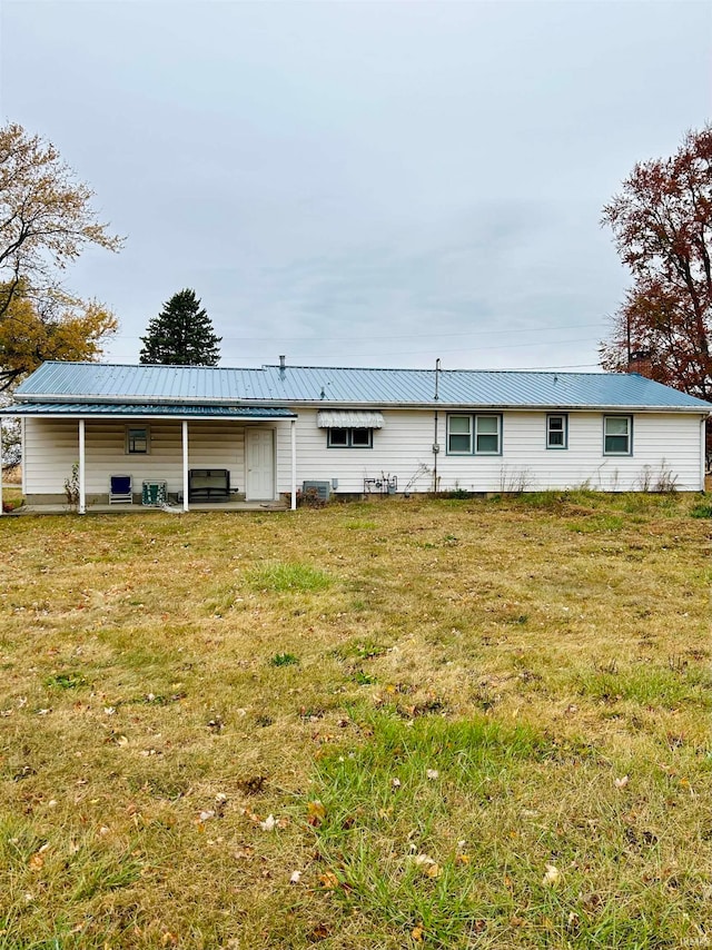 back of house with a yard