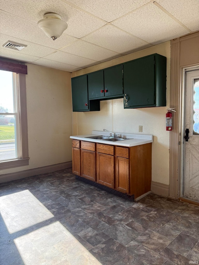 kitchen featuring a drop ceiling and sink