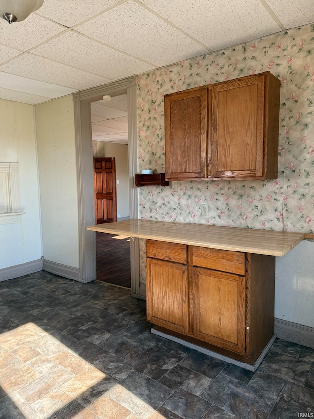 kitchen featuring a drop ceiling