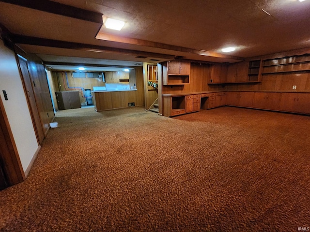 basement featuring light carpet and wooden walls