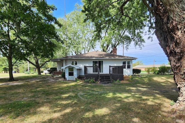 rear view of property with a yard and a deck