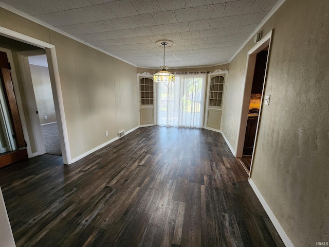 unfurnished dining area with dark hardwood / wood-style floors and crown molding