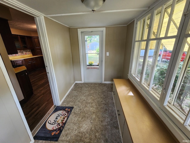 doorway featuring wood walls